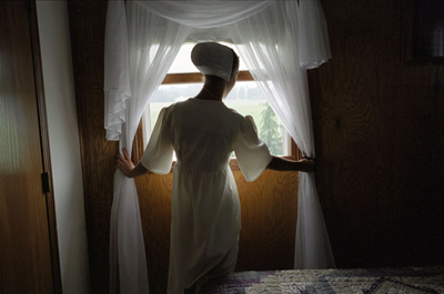 Amish Girl Opening a Window, Holmes County, Ohio ©Lauren Fleishman