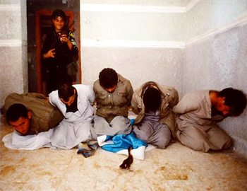Handcuffed drug traffickers, and a duck, on a porch, Egypt ©Susan May Tell